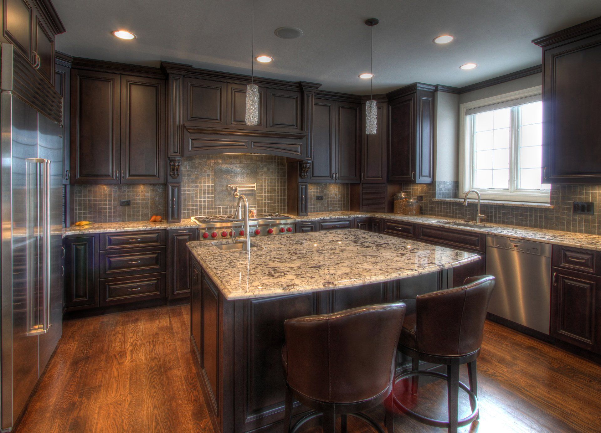 A kitchen with stainless steel appliances and granite counter tops.