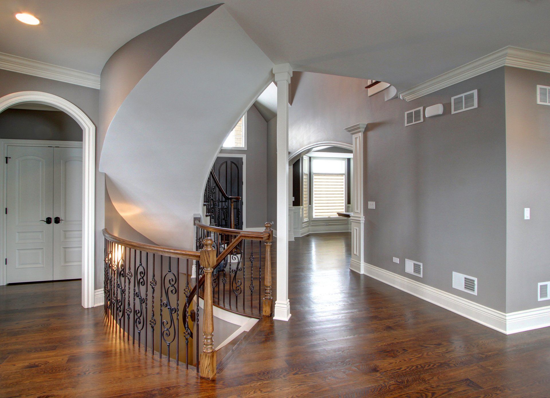 An empty hallway with a spiral staircase in the middle