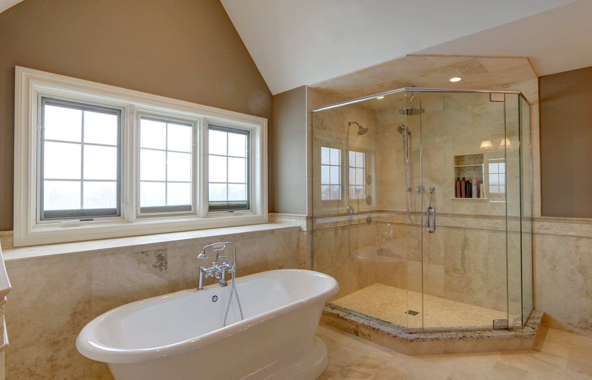 A bathroom with a tub and a walk in shower.