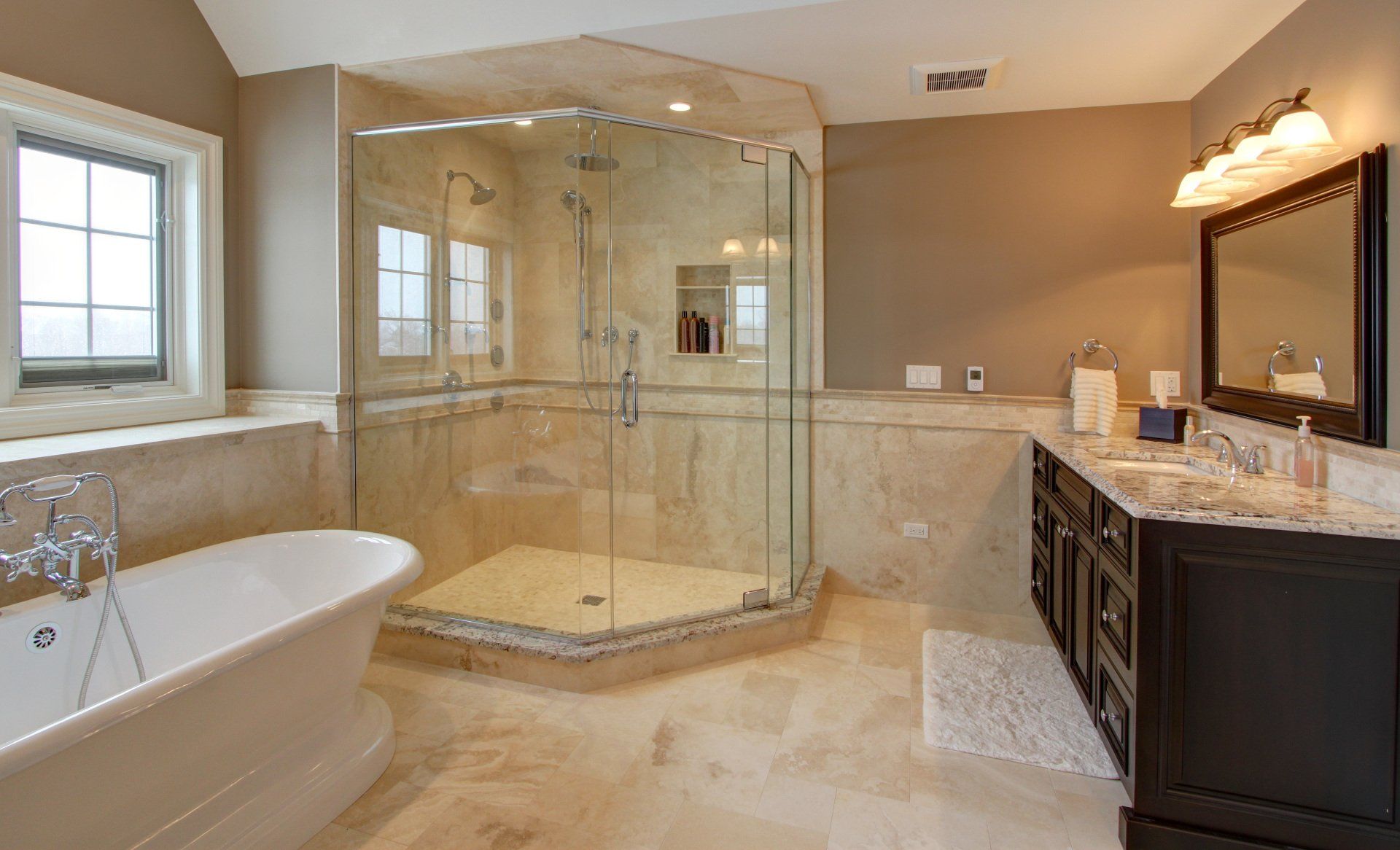 A bathroom with a tub , sink , shower and mirror.