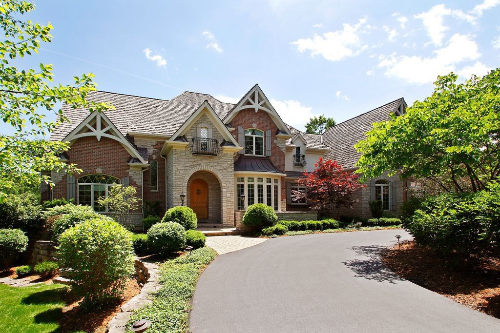 A large brick house with a driveway leading to it