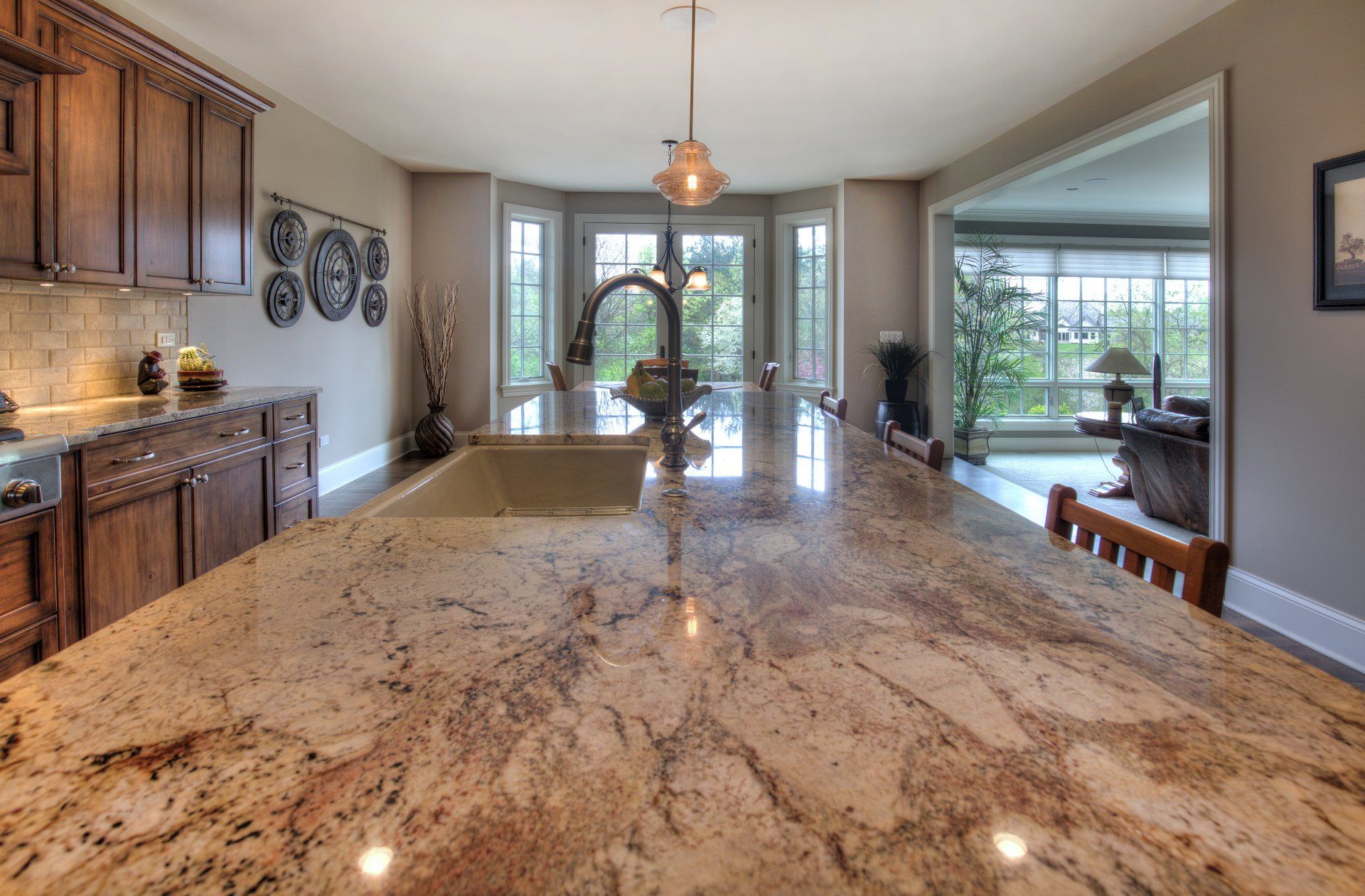 A kitchen with a large granite counter top and a sink.