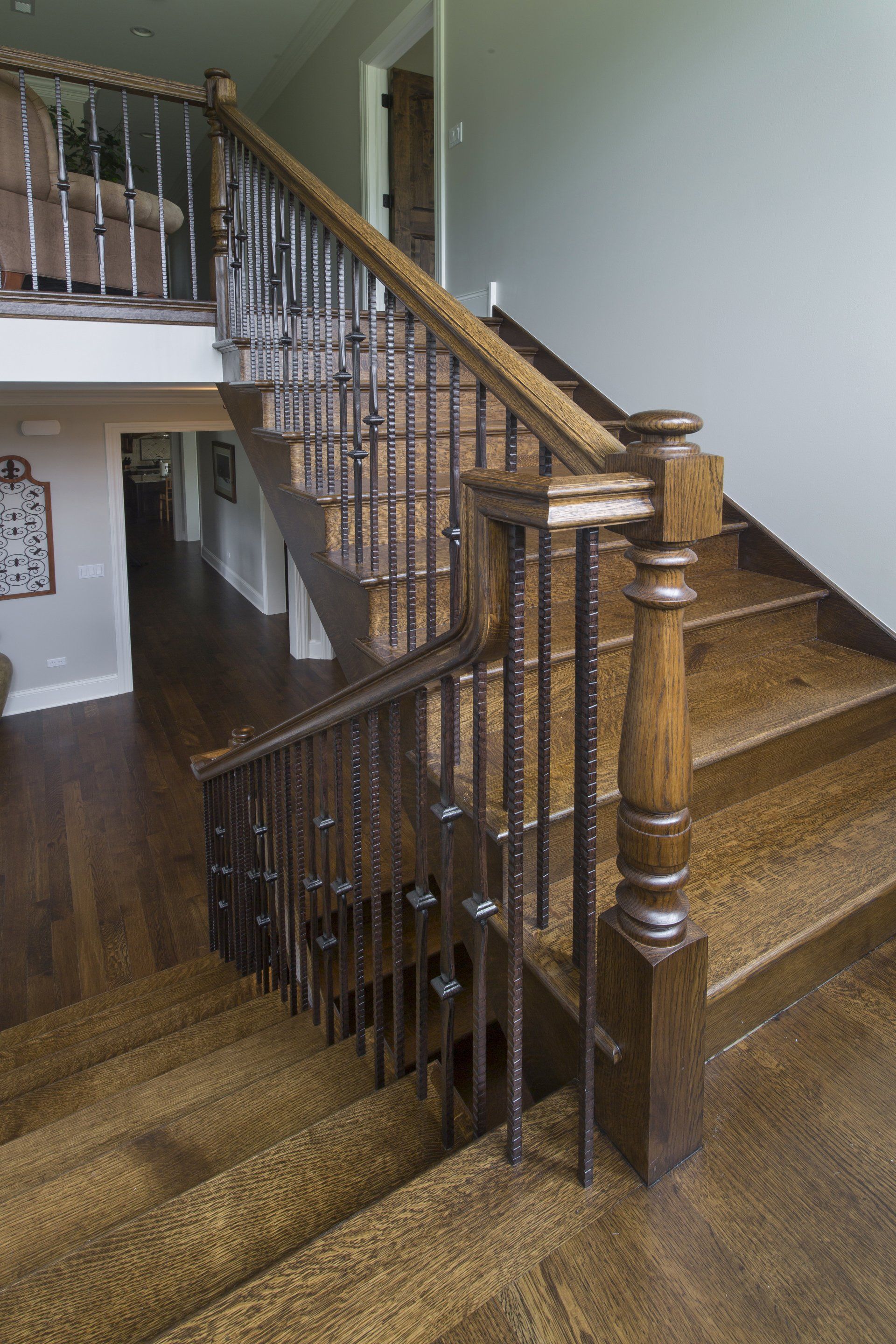 A wooden staircase with a metal railing in a house