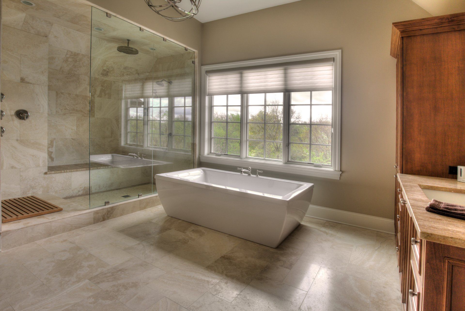 A bathroom with a tub , shower and window.