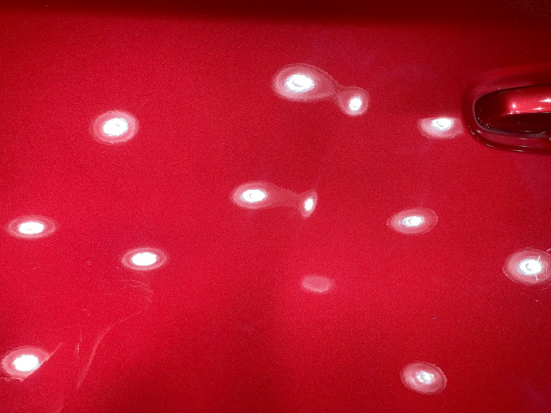 a close up of a red surface with white dots on it .