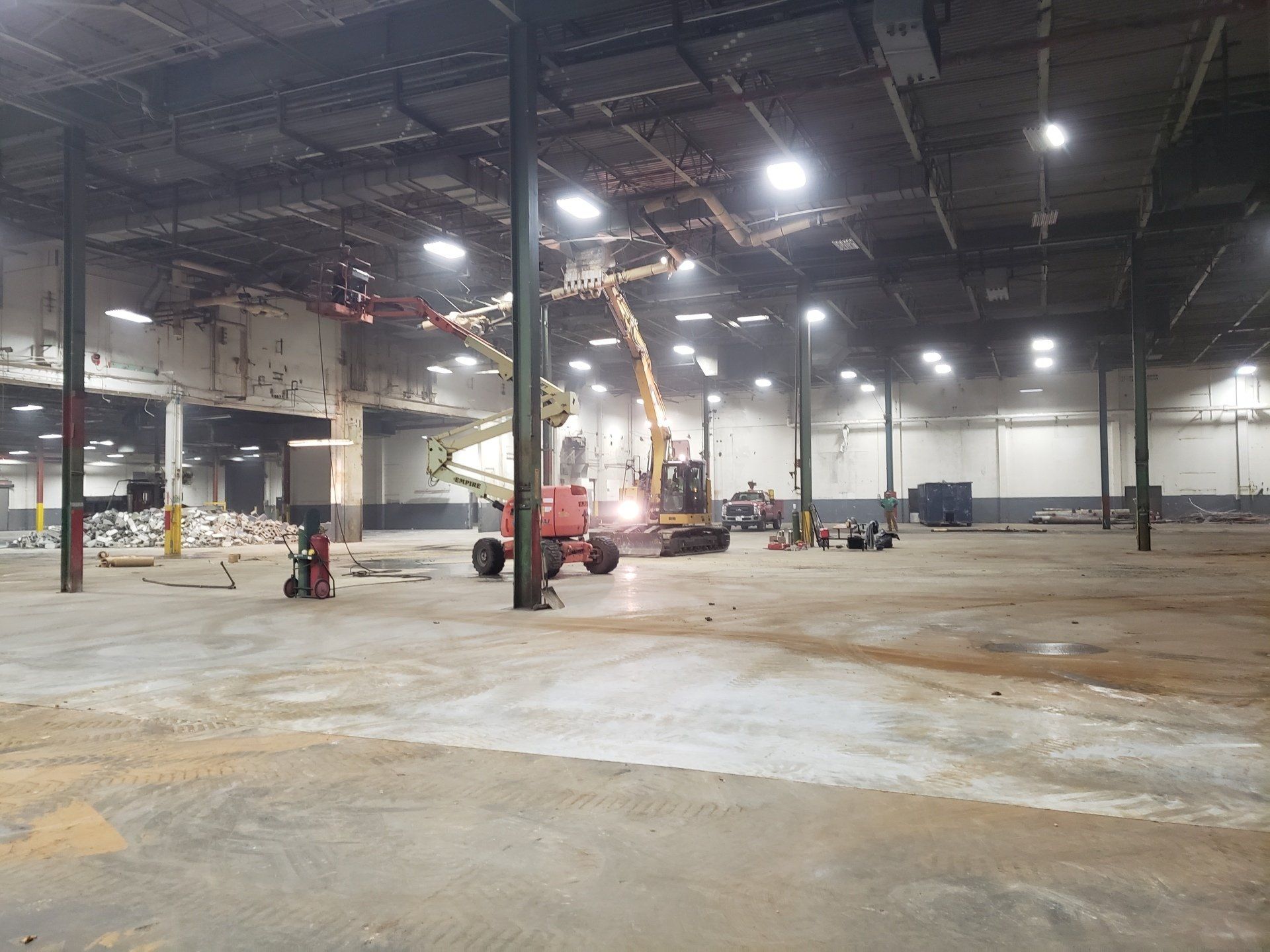 A large empty warehouse with a lot of machinery in it.