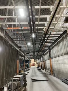 A long hallway in a building with a lot of stairs going up to the ceiling.