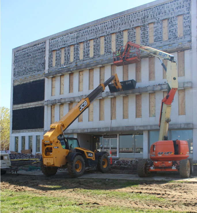 Working on the south wall of the structure to manually remove the facade and windows.