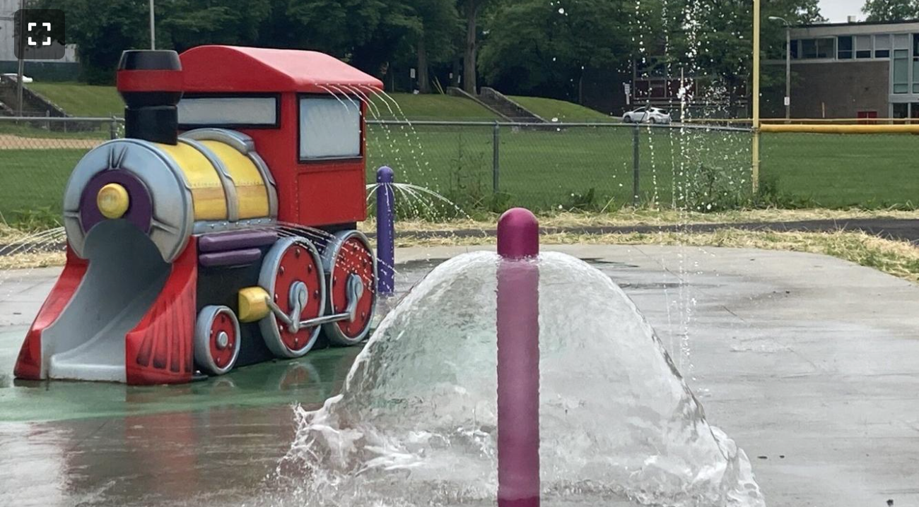 A water fountain in the shape of a train in a park