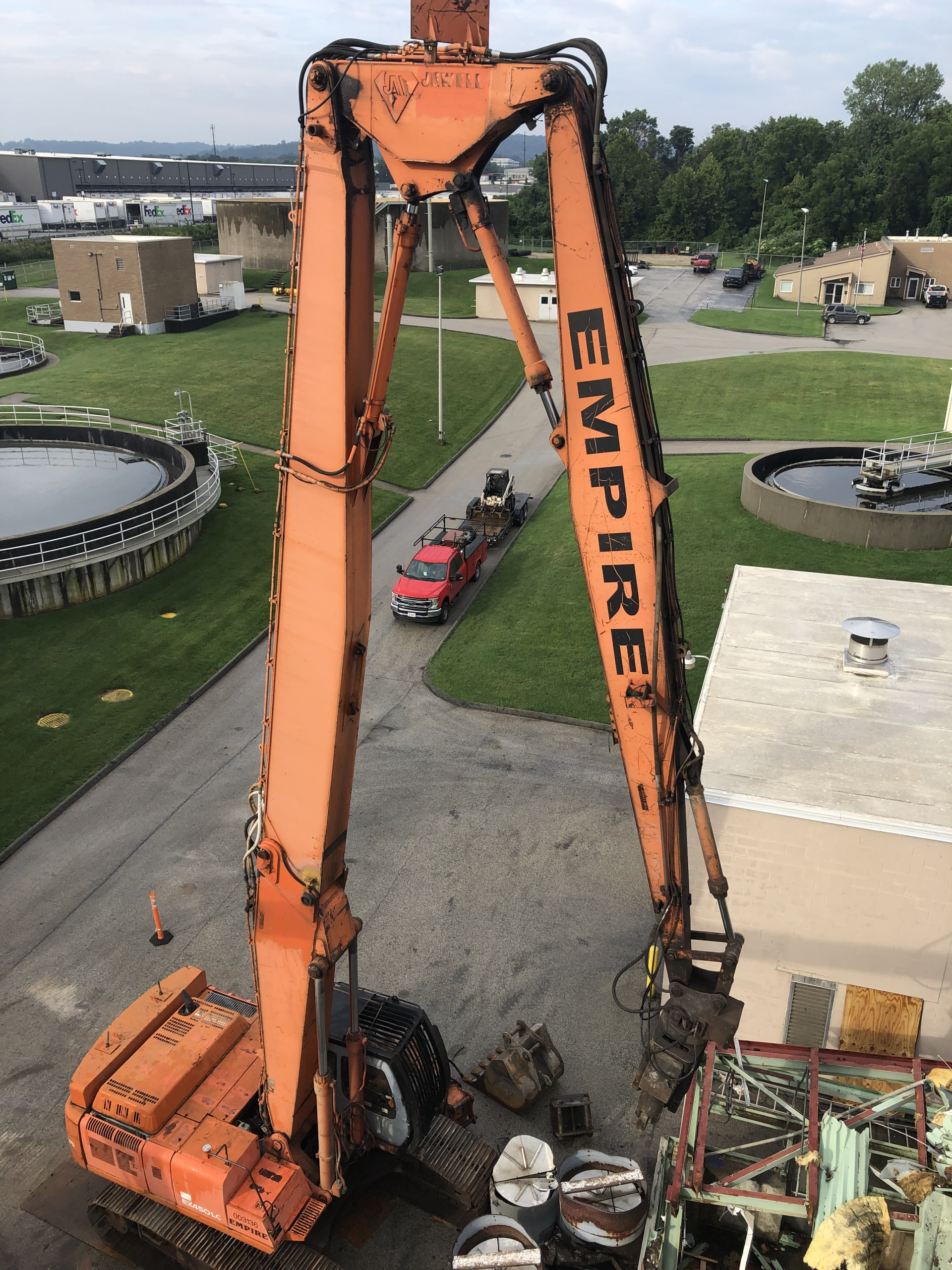 A large orange excavator with the word empire on it