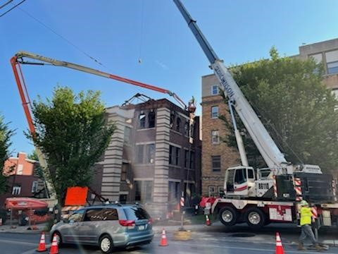 A crane is being used to pour concrete into a building
