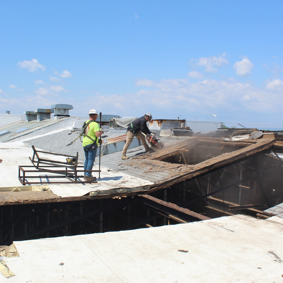 Hand demolishing a the roof at processing plant.