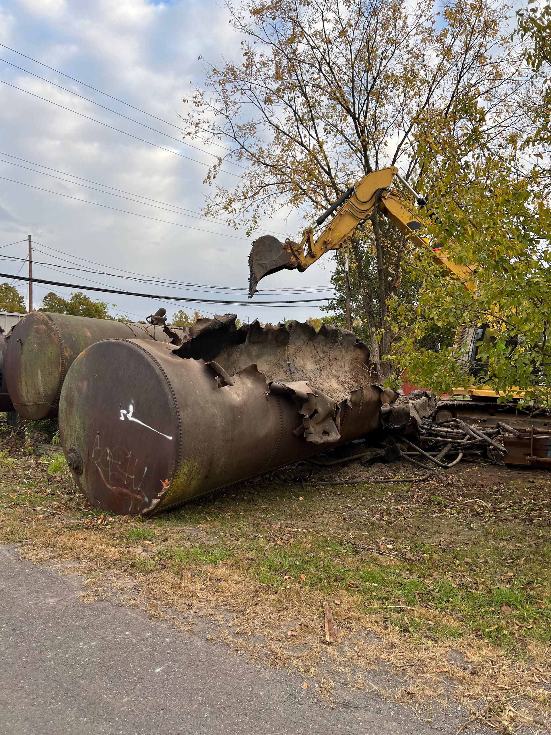 Opening up an above ground storage tank to remove any waste materials before disposal.