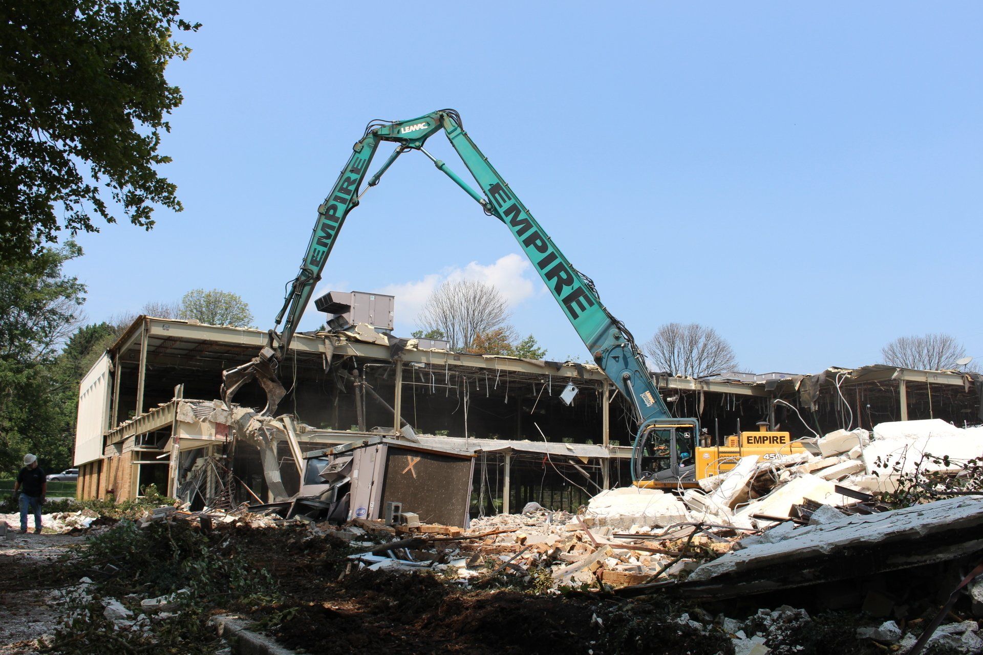 A large empire excavator is demolishing a building