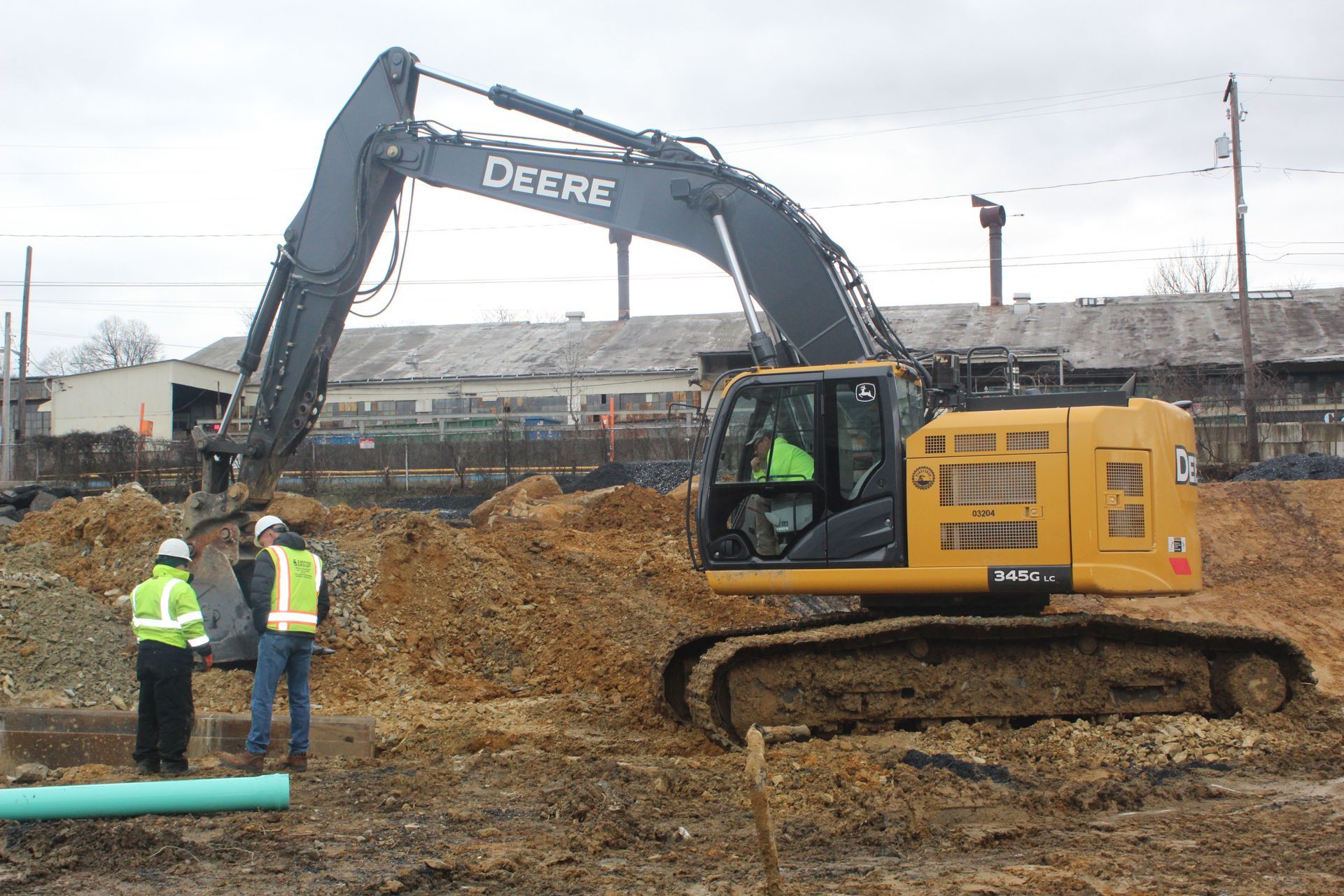 A deere excavator is being used on a construction site