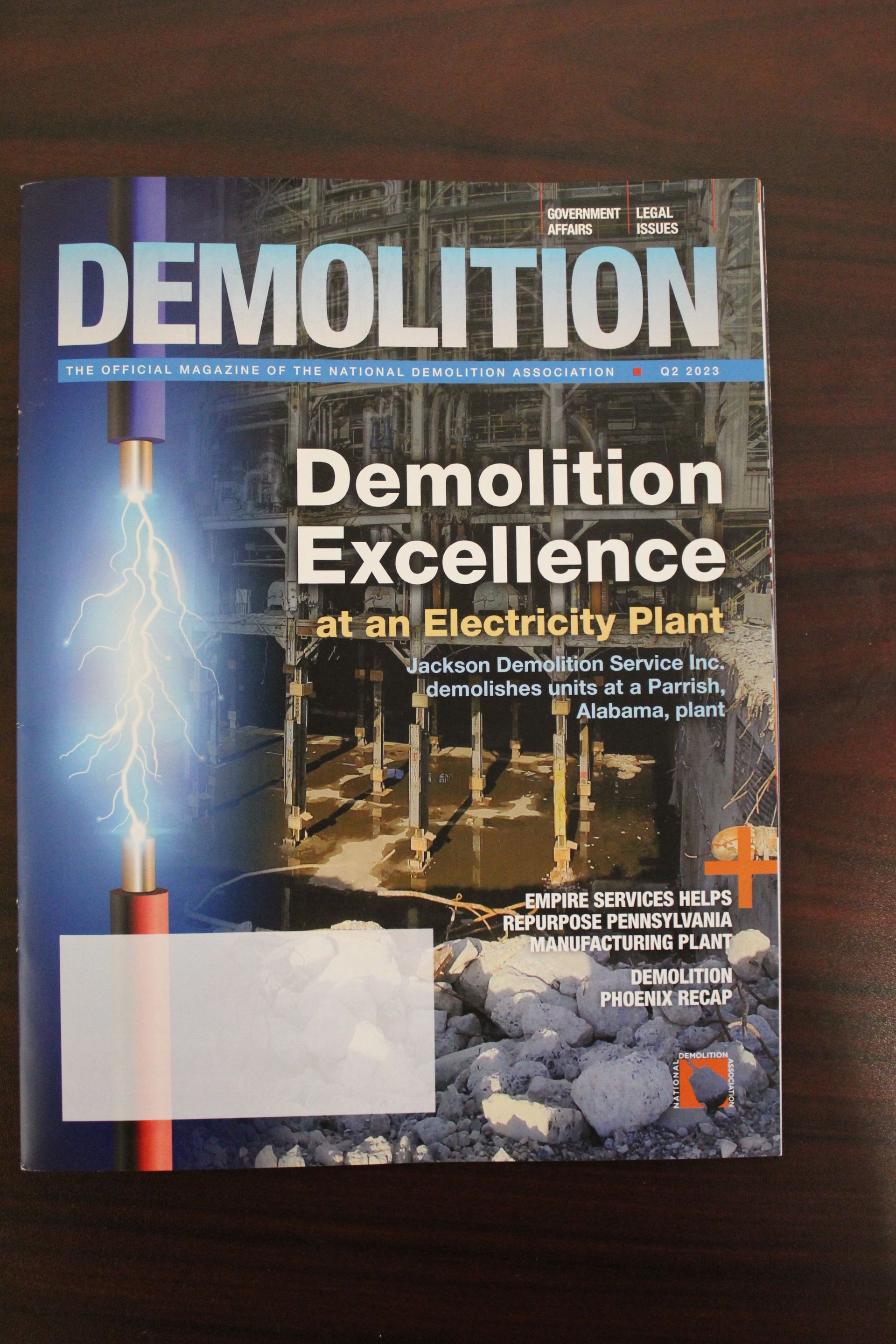 the cover of a magazine titled demolition excellence at an electricity plant