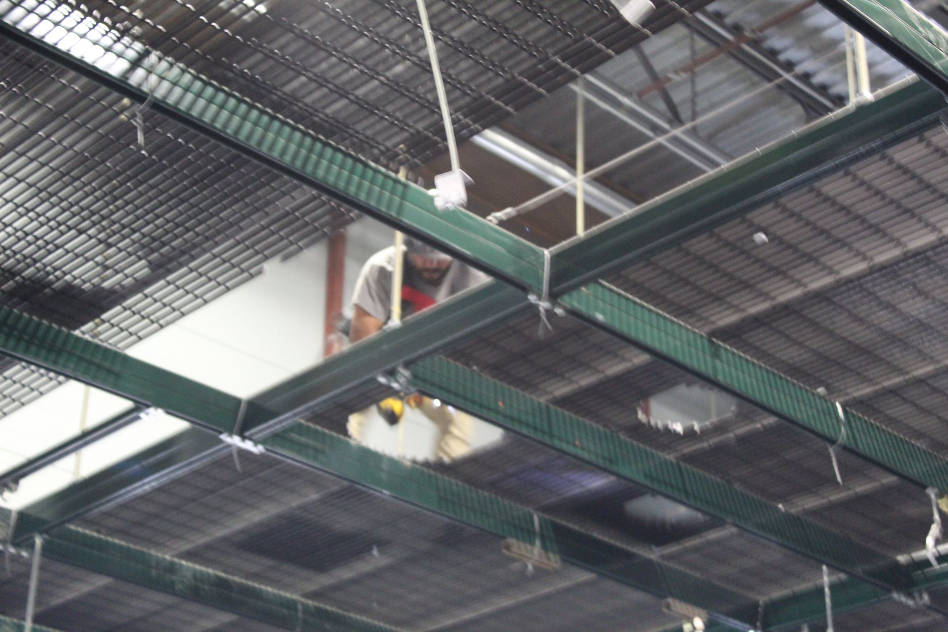 A man is working on removing pieces of the mezzanine  