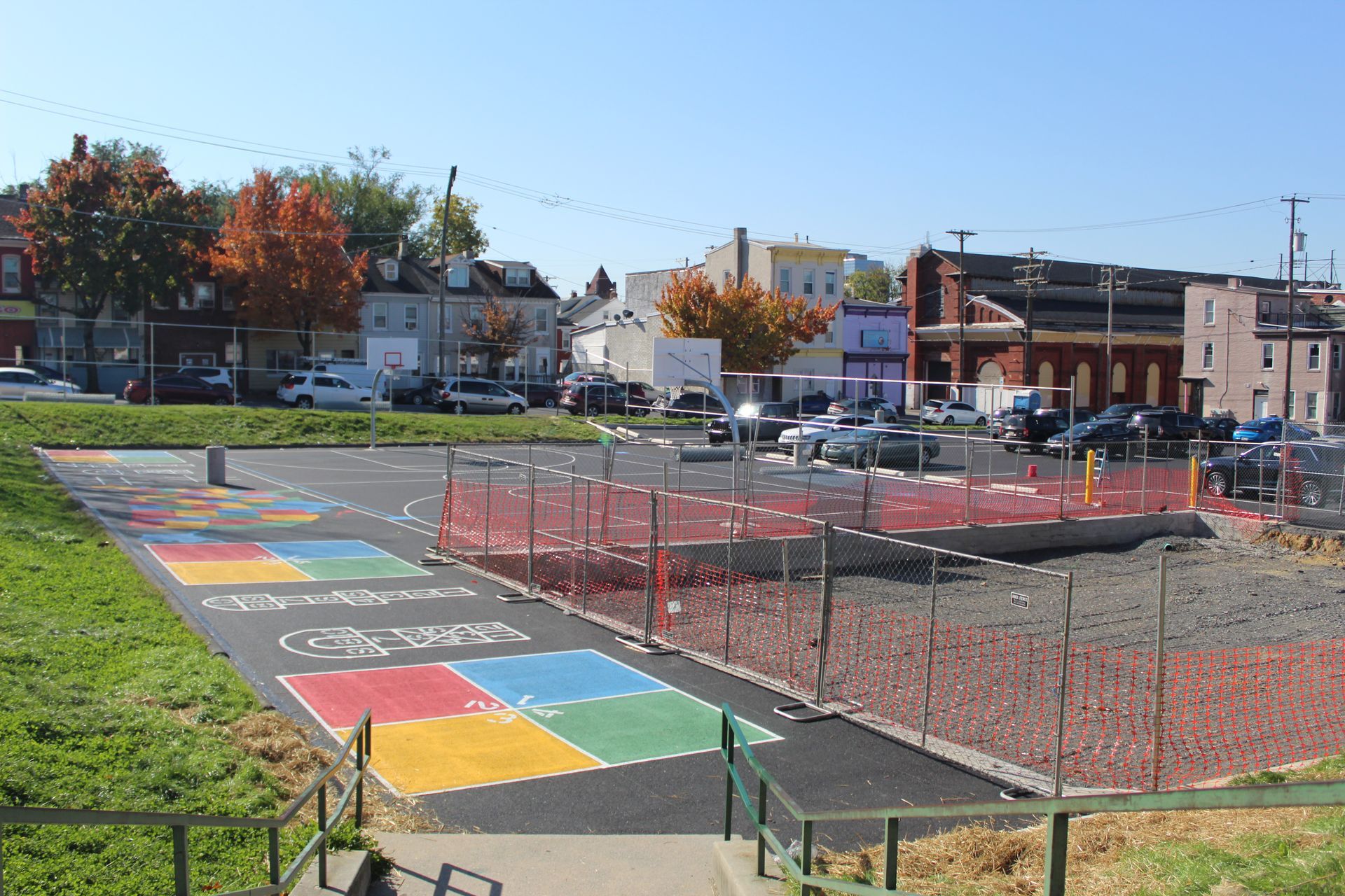 A parking lot with a colorful hopscotch in the middle of it