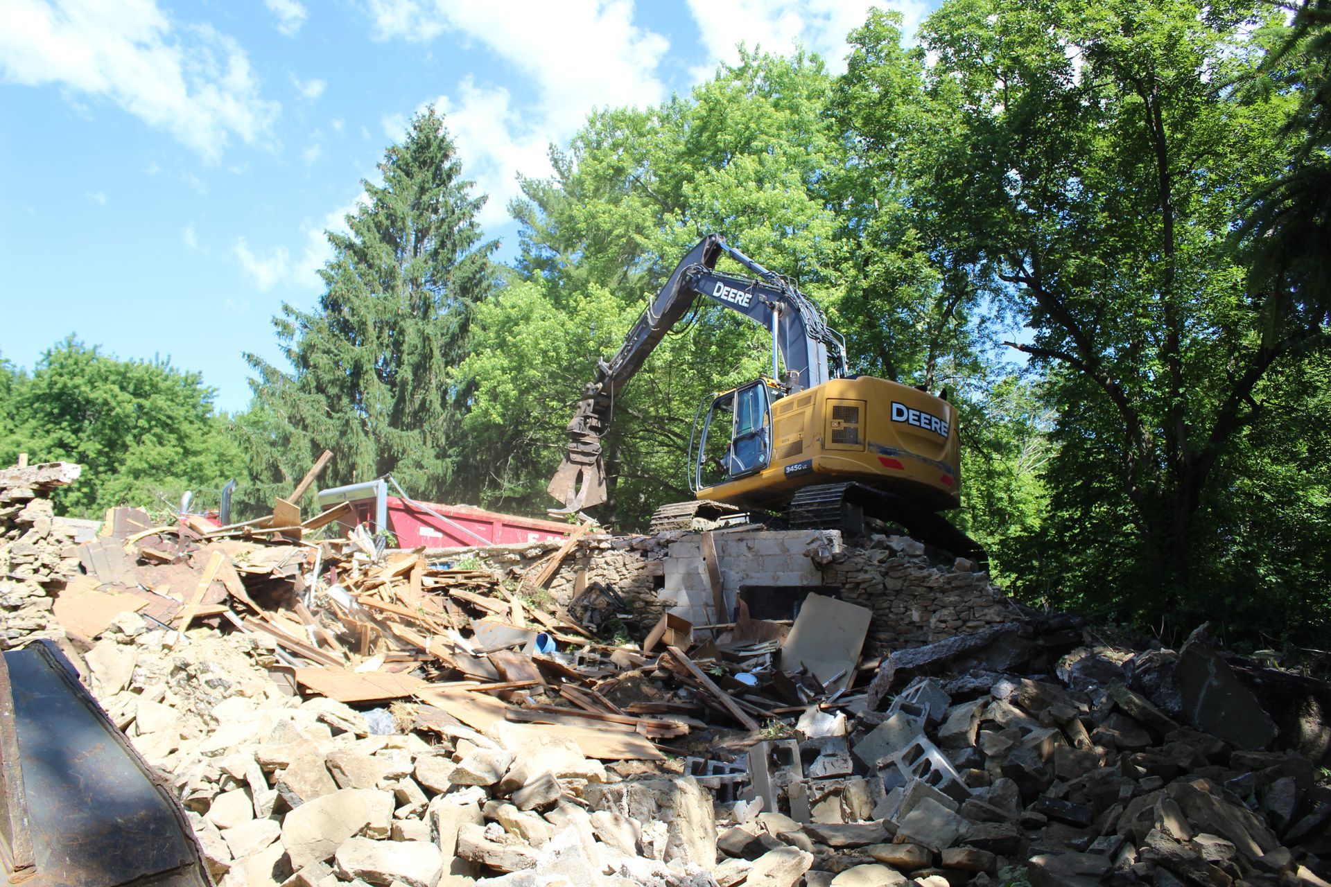 DVC dump truck receiving a load of debris from barn demolition.