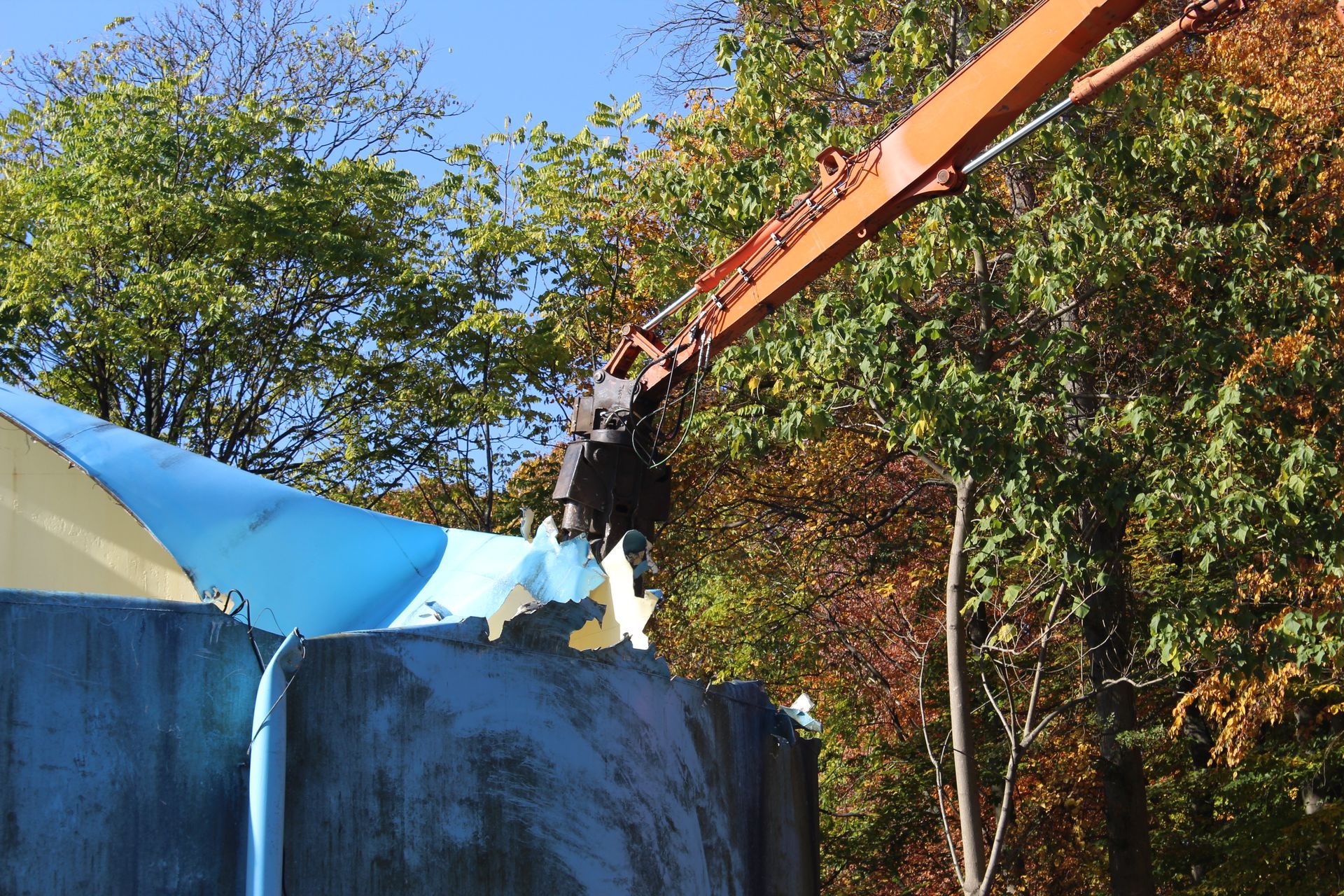 The shear cutting the steel tank. 