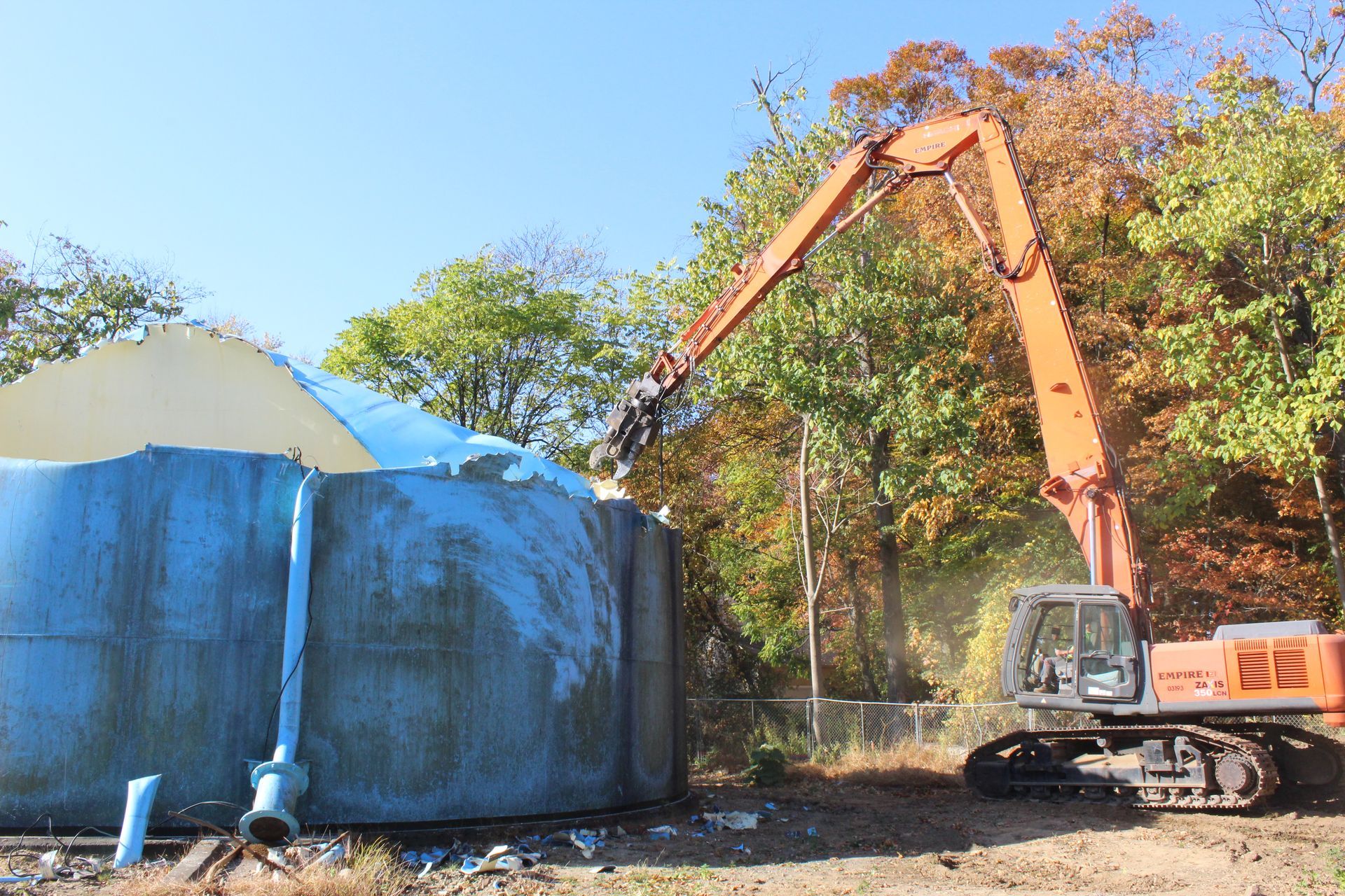 Cutting up the blue water tank with shears. 