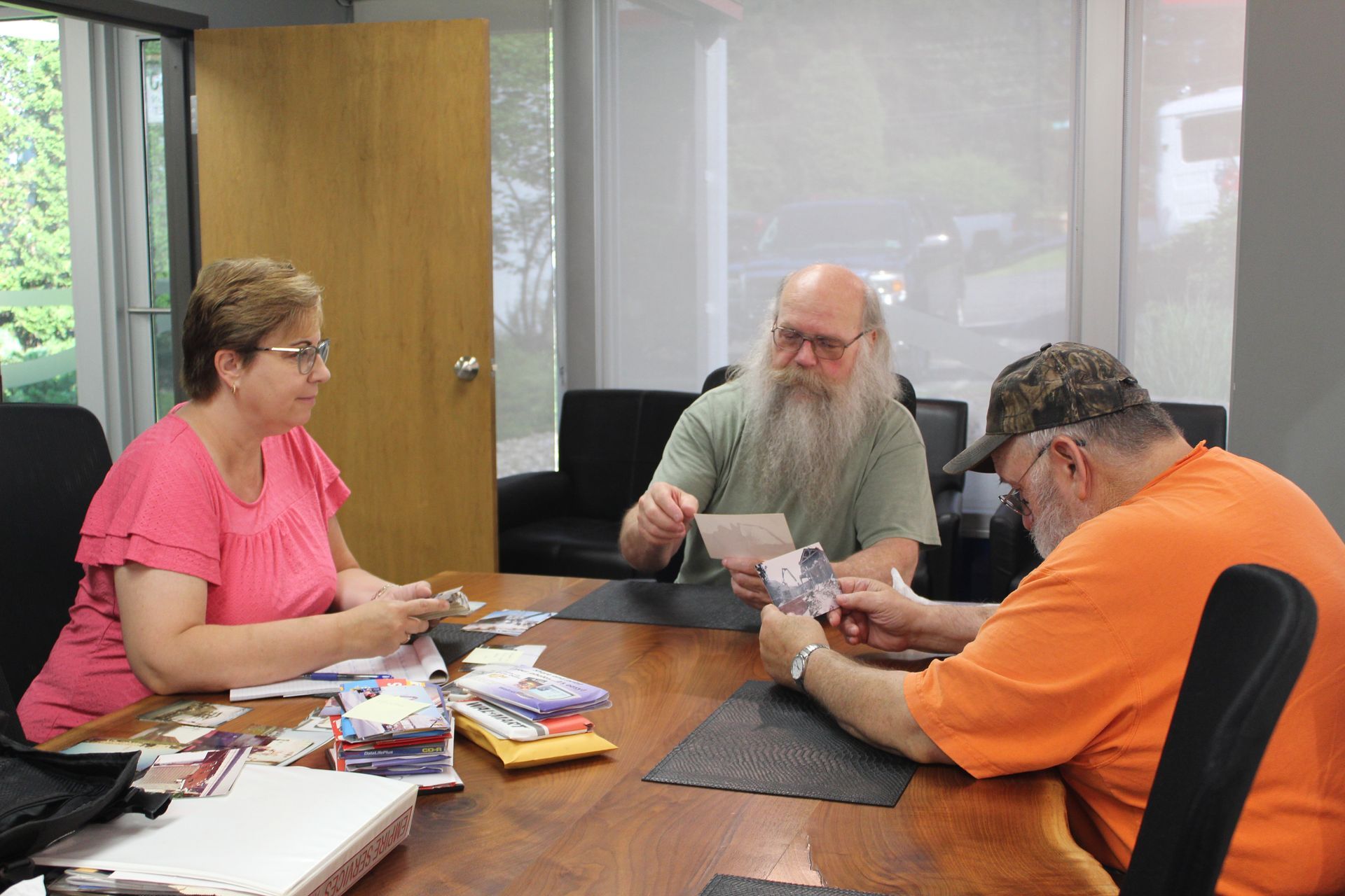 Poring over photographs with two former Empire Group employees.