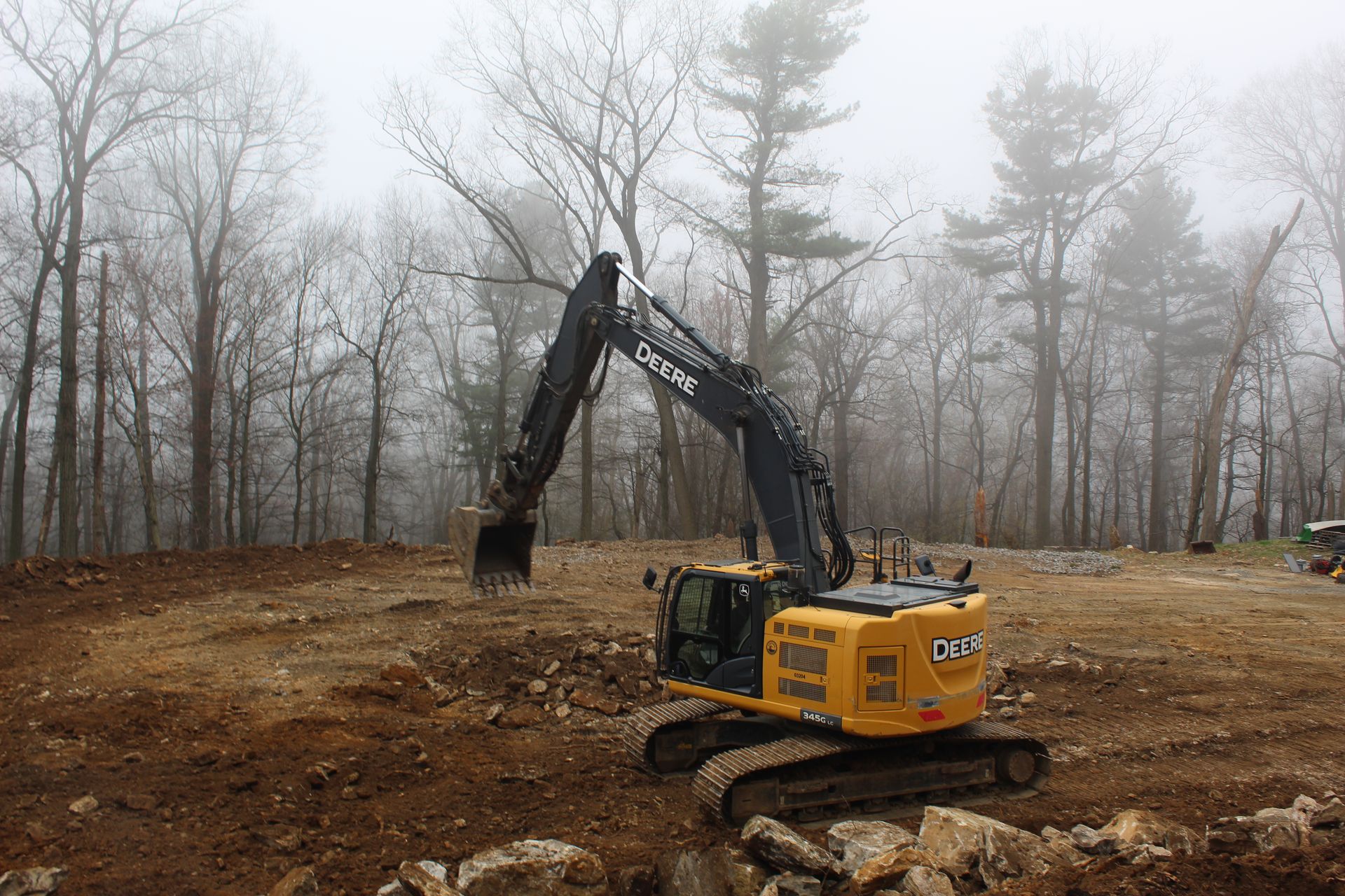 One of Empire Service's excavator is removing rocks from the site.