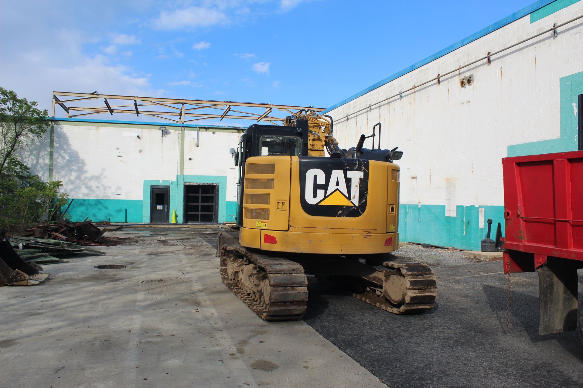 One of Empire Services excavators that was utilized to remove the grates on top of the pit and remove debris from inside it. 