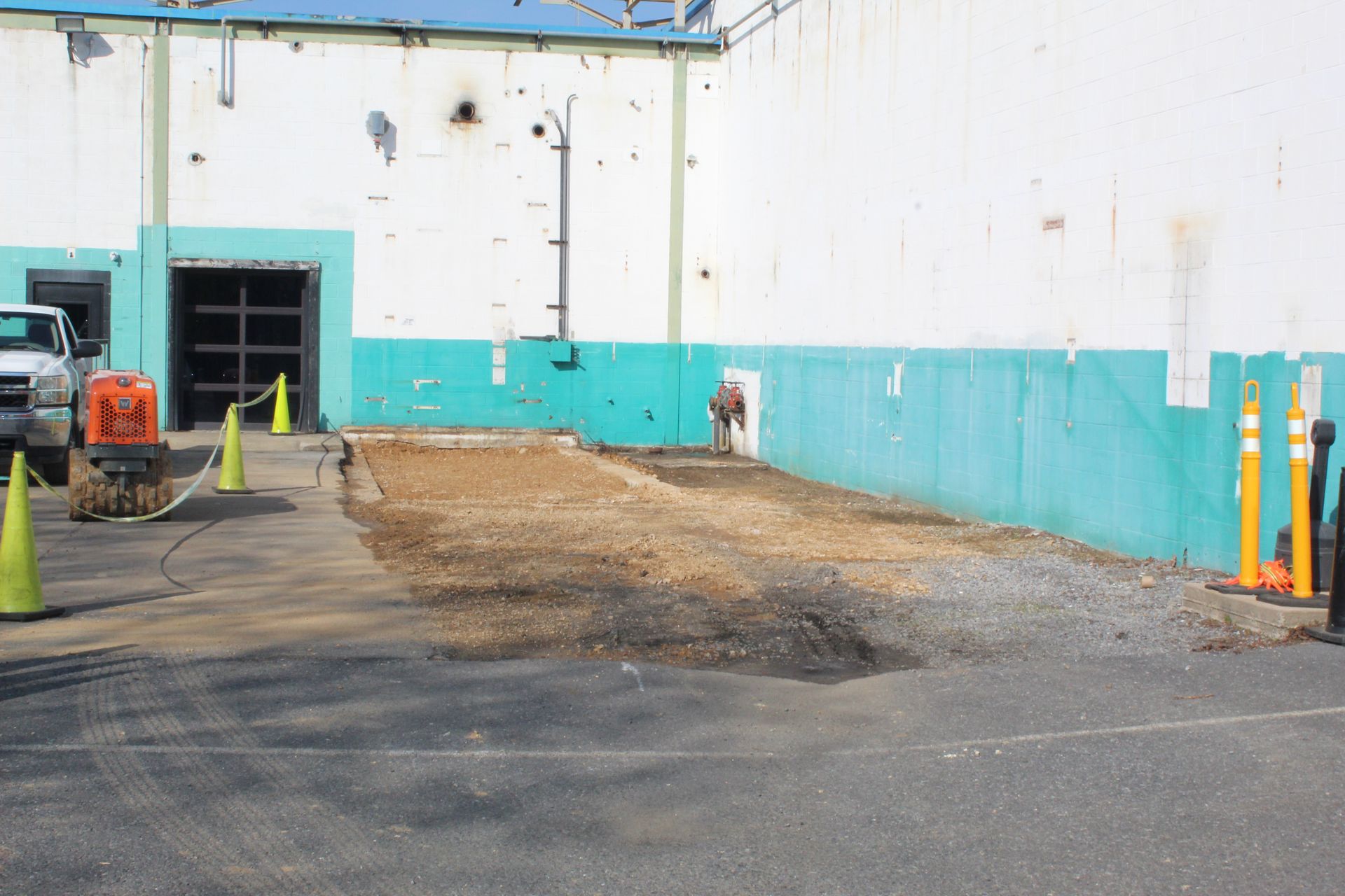The utility pit is level with the asphalt.