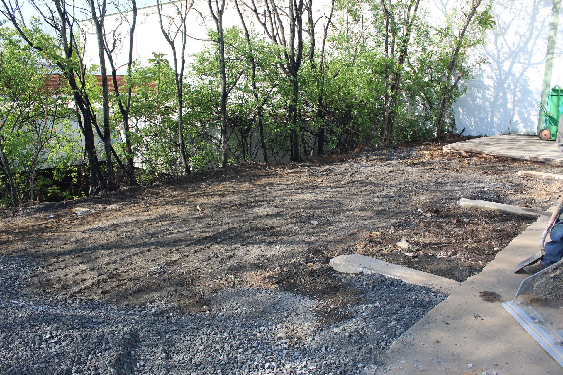 Area to the left of concrete slabs to be filled and leveled. 