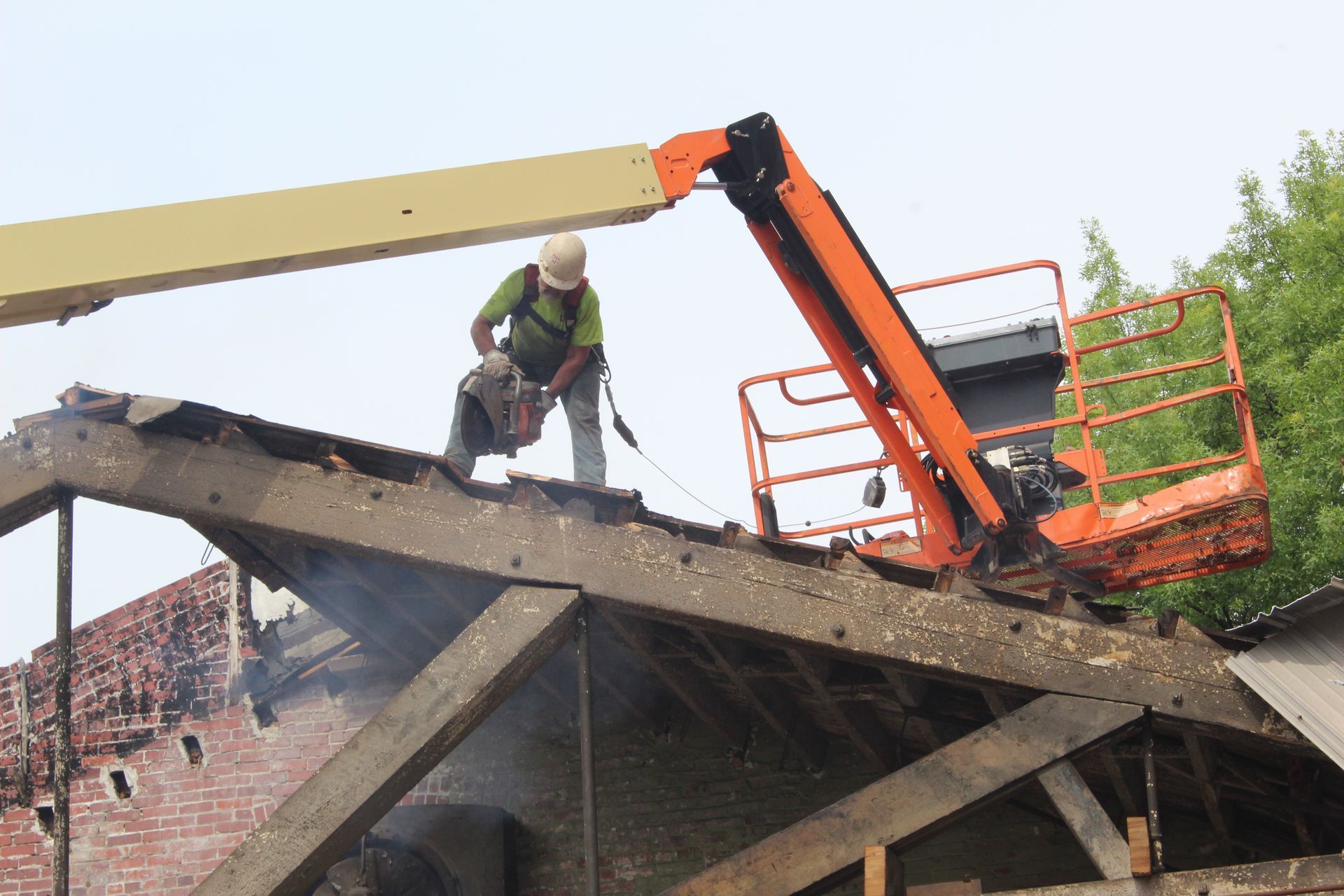 An Empire Services crew member uses a circular saw to remove the roof.