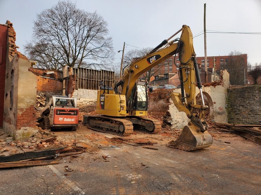 A bulldozer is being used to demolish a building.