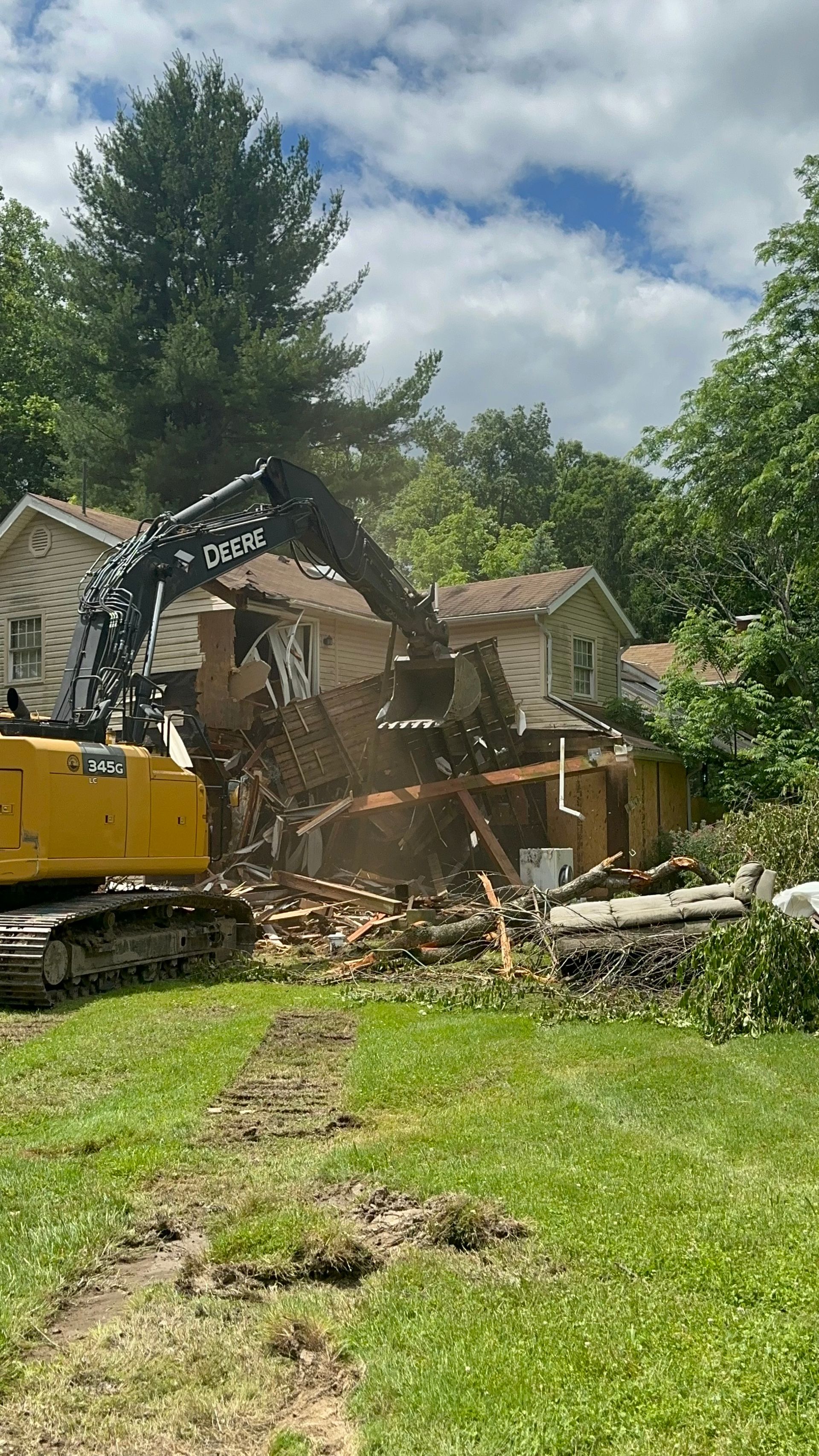 A house is being demolished by a bulldozer.