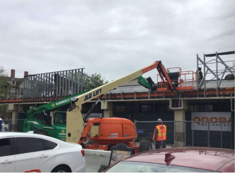 A jlg lift is being used to build a building