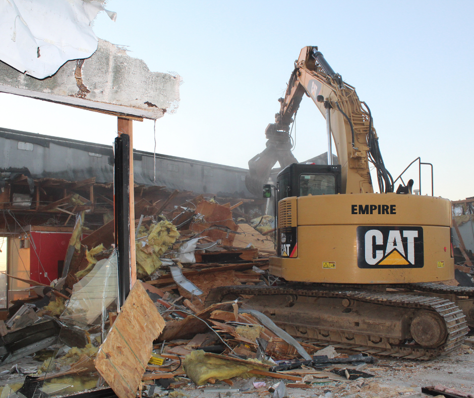 One side of a fast food restaurant being demolished.