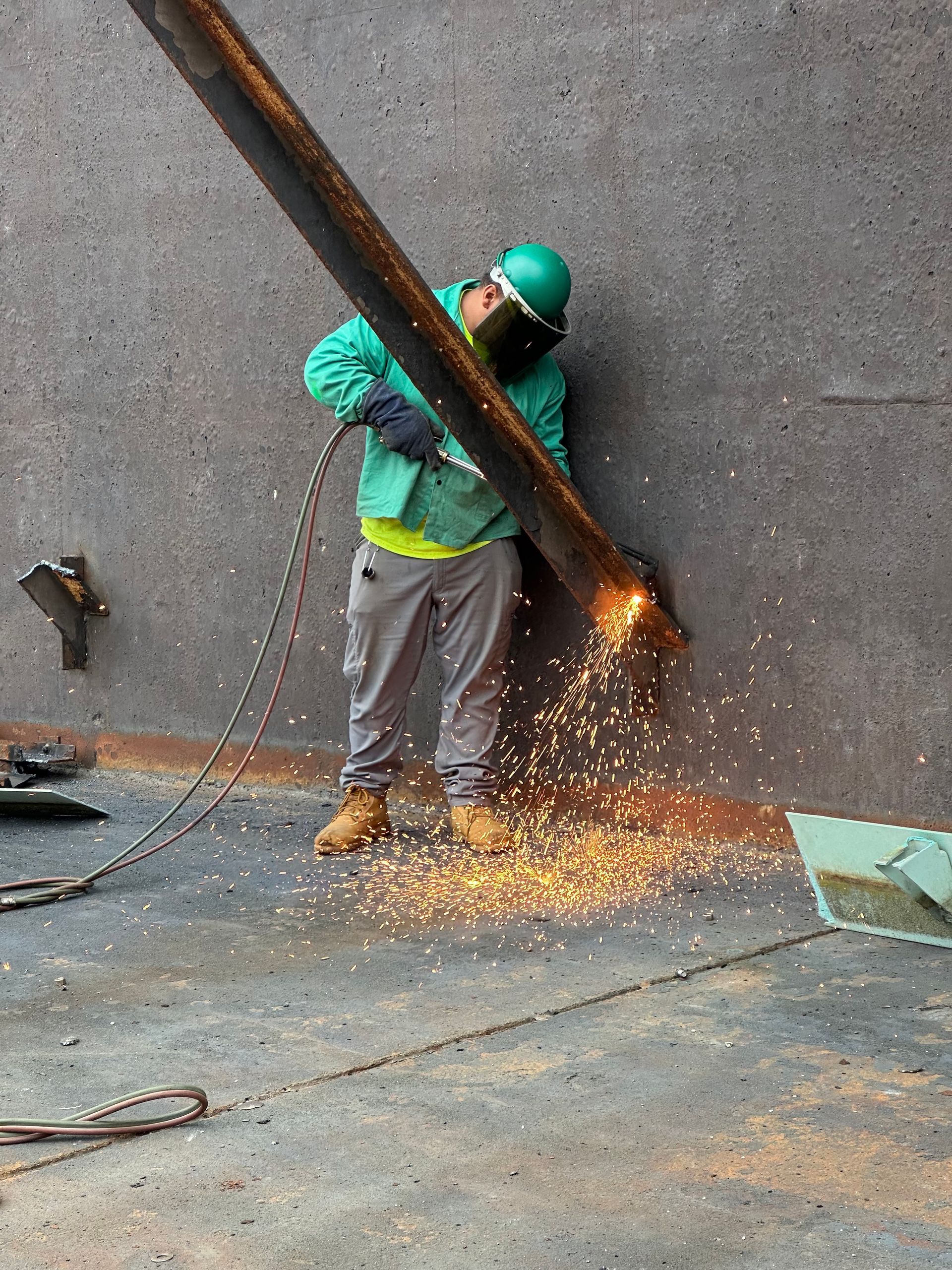 Torch cutting one of the many steel structural supports. 