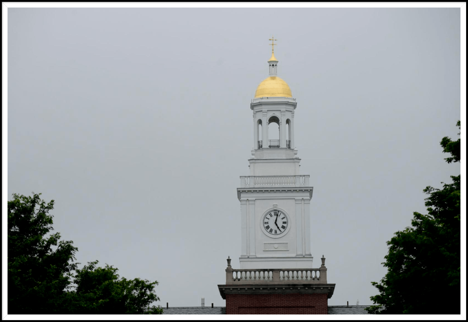 A clock tower with a gold dome on top of it
