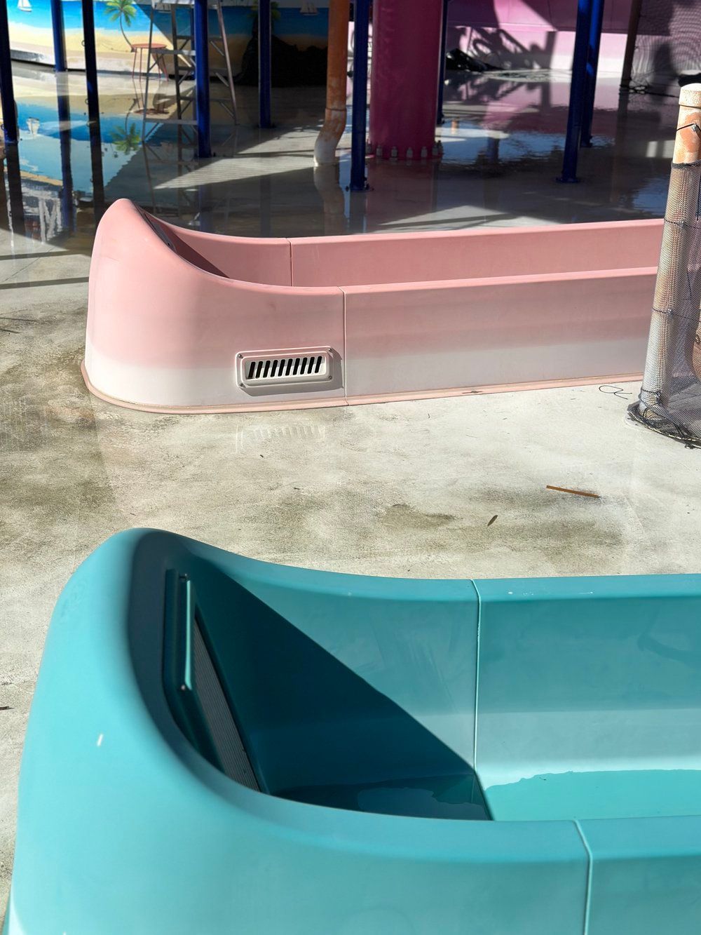 Faded water slide section with worn pink gelcoat before restoration