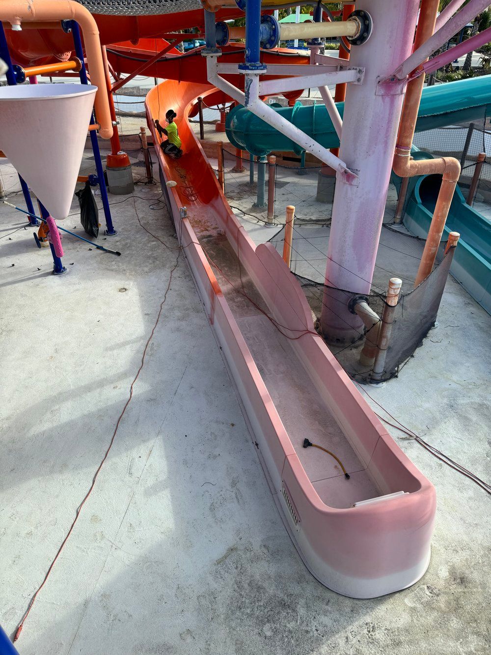 Water slide undergoing fiberglass repair and gelcoat preparation