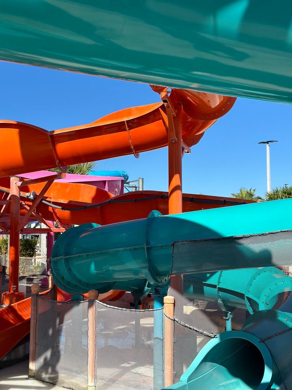 Fully restored teal water slide with vibrant color and smooth finish