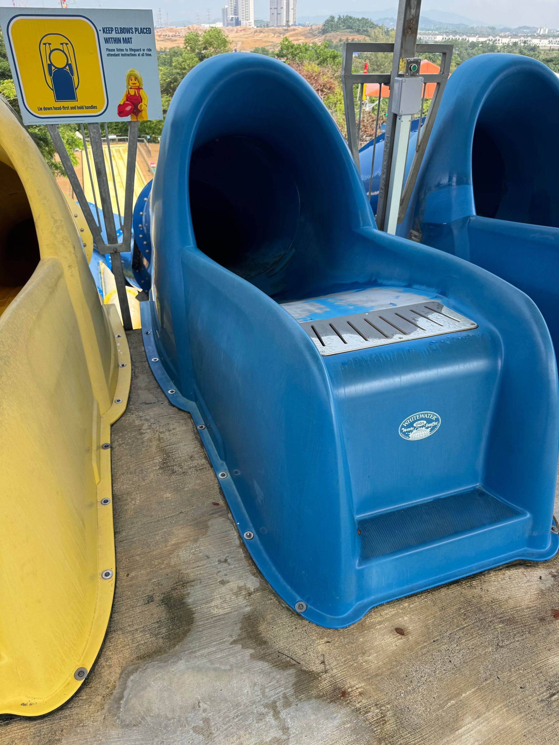 Blue waterslide launch chute at Legoland Malaysia showing surface wear before restoration
