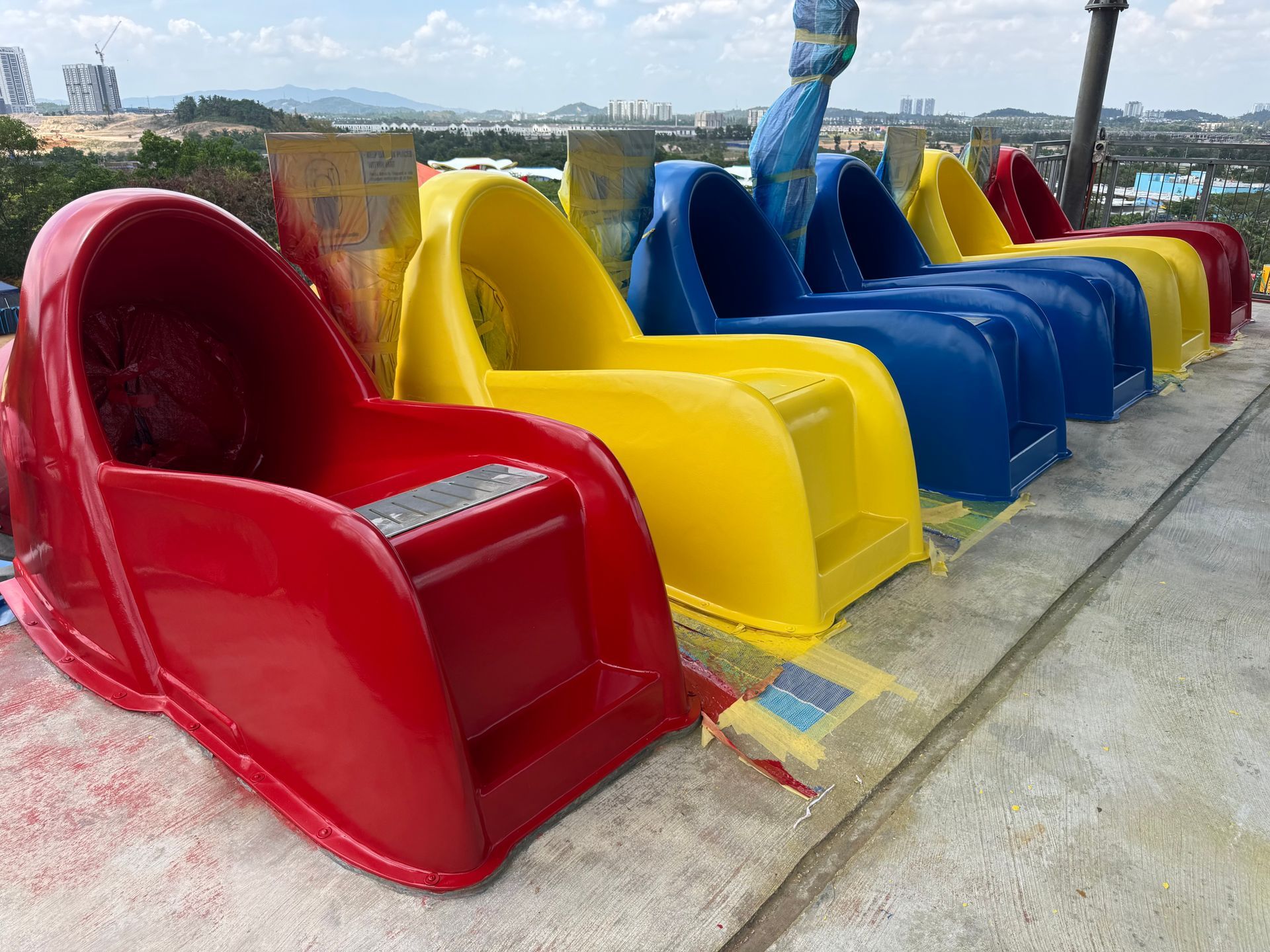 Fully restored red, yellow, and blue waterslide launch chutes with glossy gelcoat finish after restoration at Legoland Malaysia
