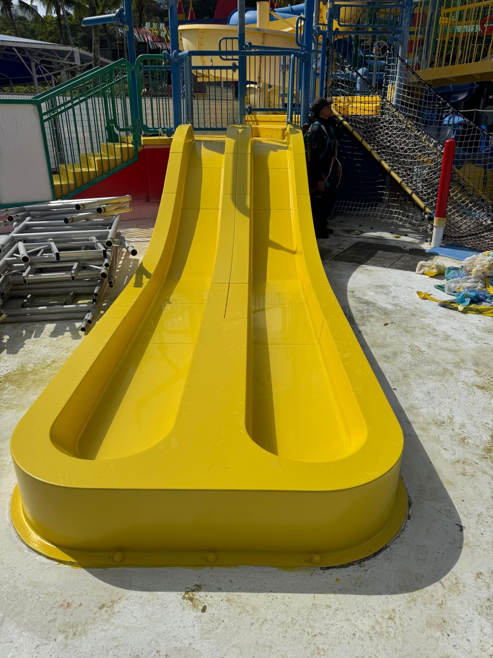 Restored dual-lane yellow waterslide runout with smooth glossy gelcoat finish at Legoland Malaysia