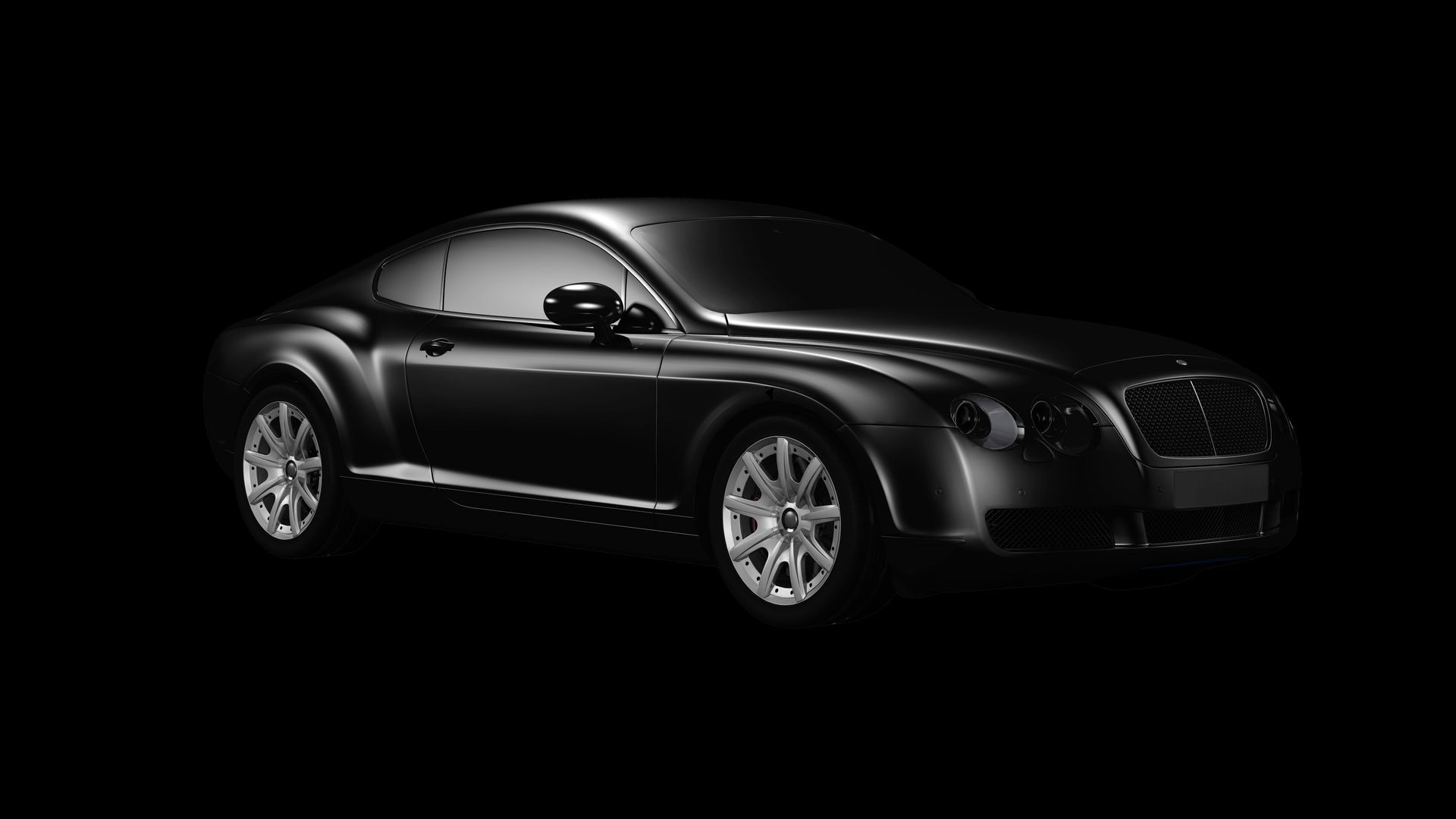 A black car is parked in the dark on a black background.