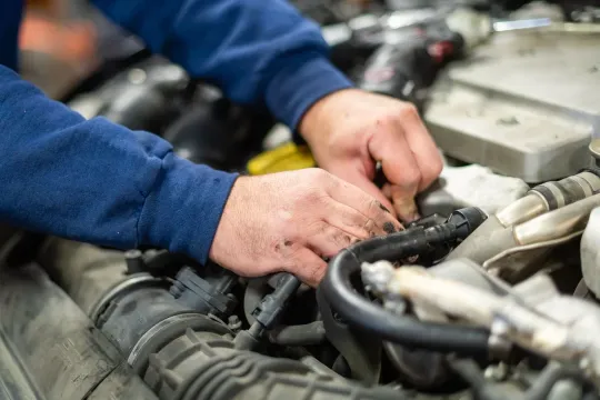 A mechanic working on a vehicle | Texas Automotive Performance
