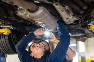 Two mechanics repairing a vehicle | Texas Automotive Performance
