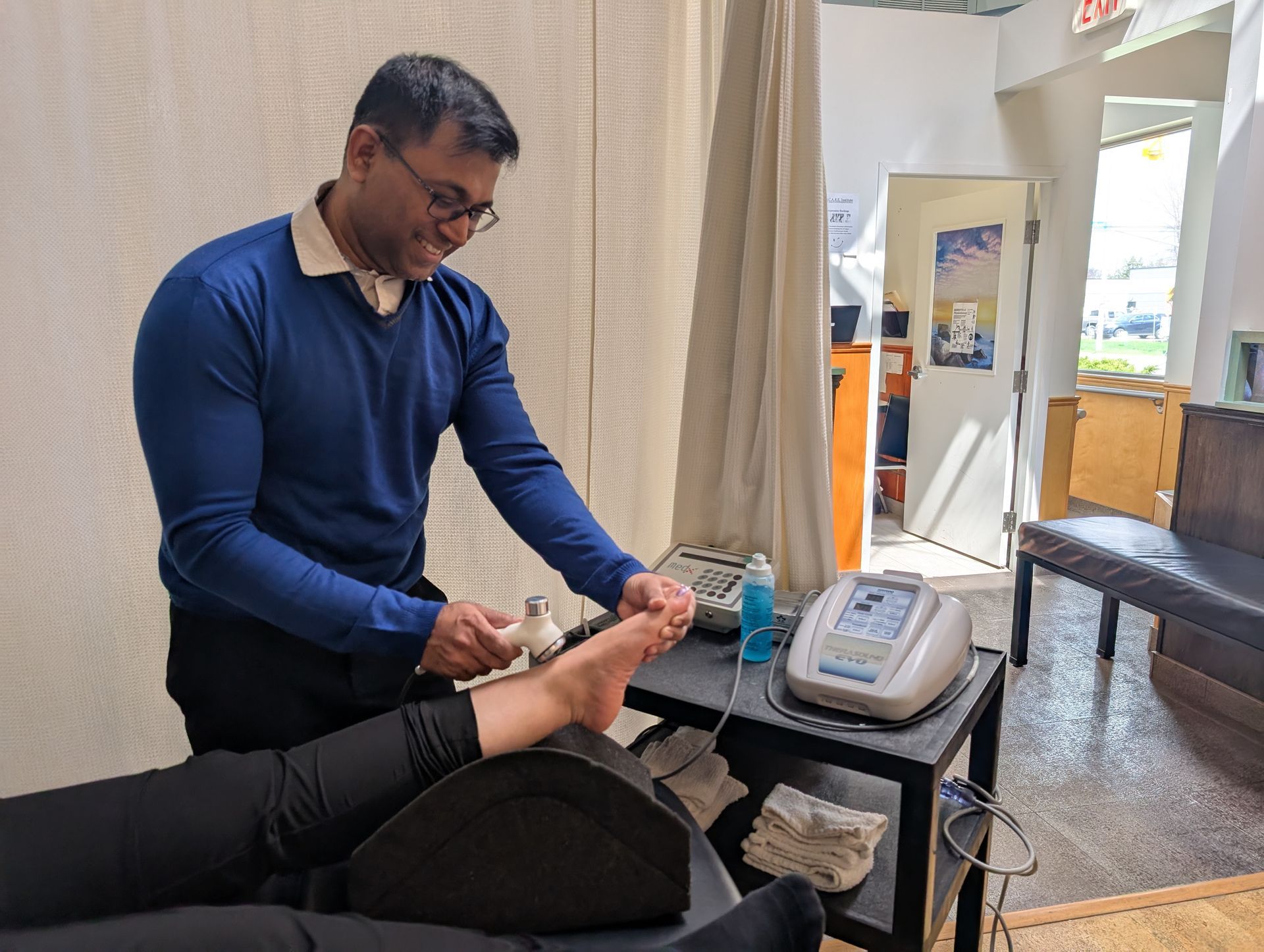 A woman is getting her wrist examined by a doctor.