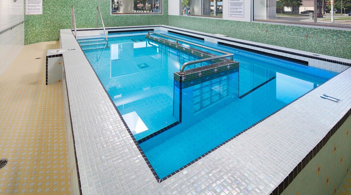A woman is laying in a jacuzzi in a spa.