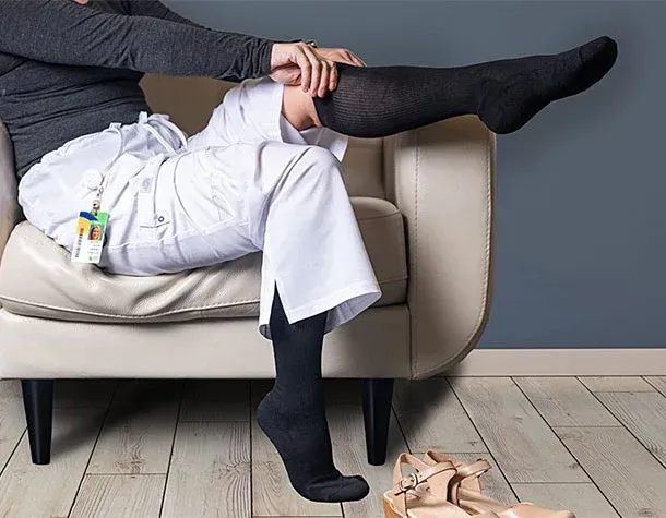 A man is wearing a posture corrector on his back.