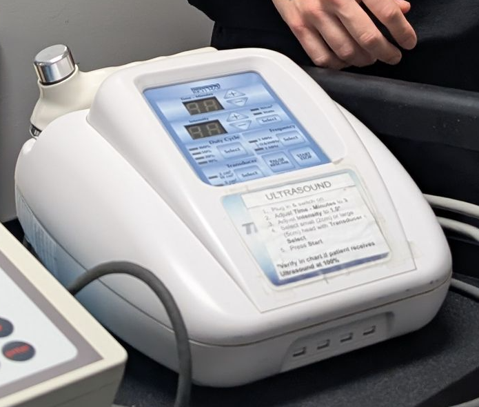 A man is wearing a posture corrector on his back.